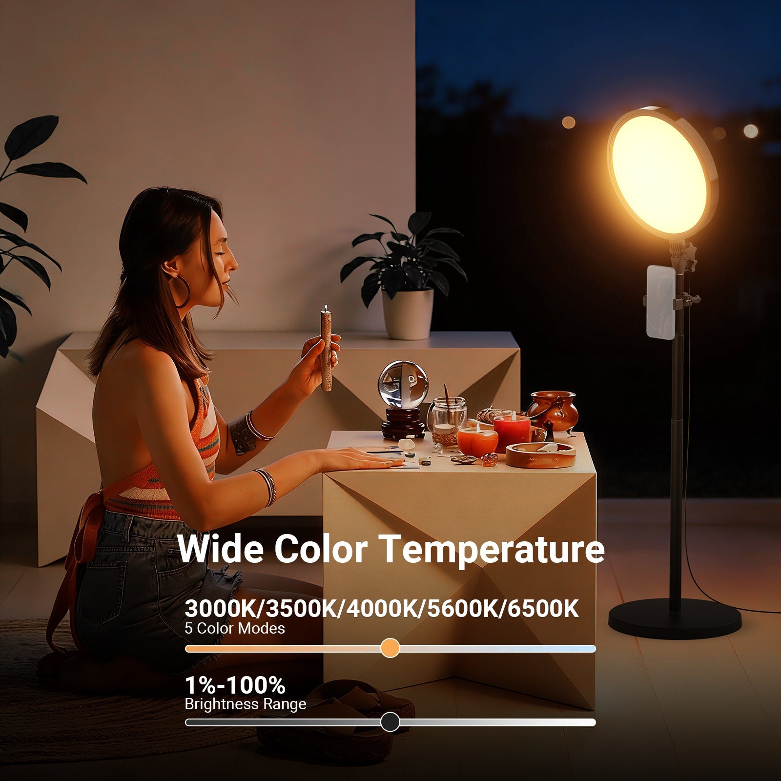 The NEEWER BR45B ring light with a phone mount casts a warm, soft glow on a woman performing a spiritual ritual at dusk, providing ideal lighting for filming a wellness or spiritual content video.