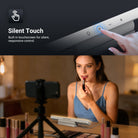 A woman doing a makeup vlog at home, using the NEEWER TL106B LED Chin Fill Light to create soft, even illumination on her face, while filming with a smartphone on a tripod.